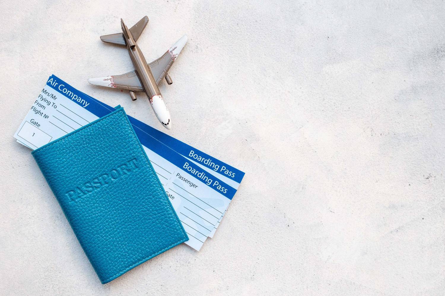 A Boarding Pass Lying On A Table With A Passport