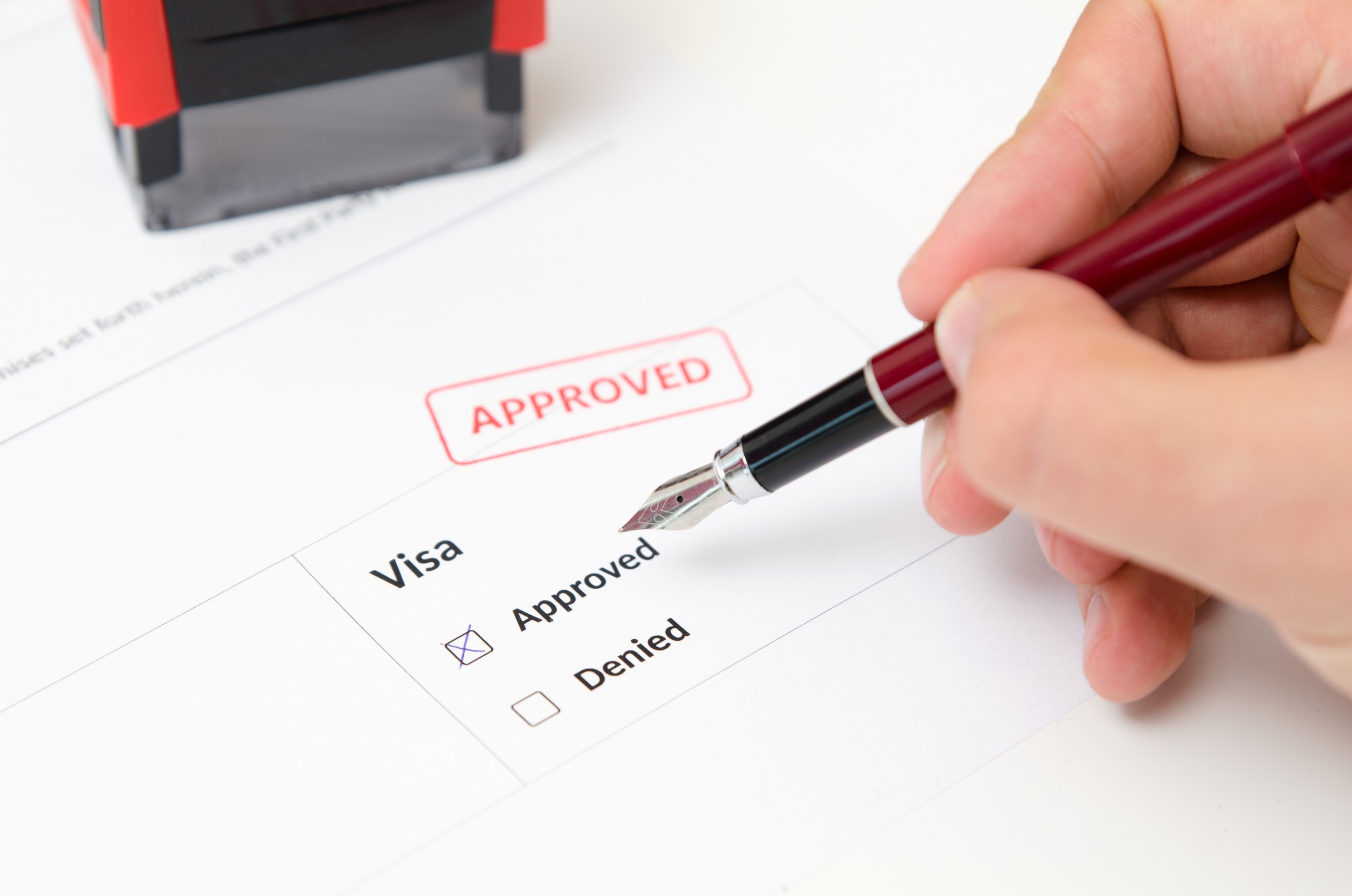 Visa and Approved Stamp on a Document Form Immigration